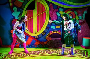 Two characters face each other across a brightly coloured backdrop.